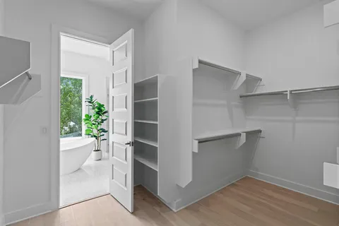 a view of walk in closet with empty racks