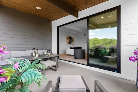 a dining room with furniture and a potted plant