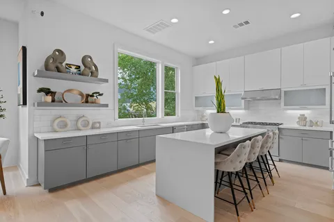 a kitchen with a sink stove and cabinets