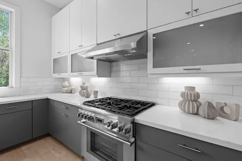 a kitchen with granite countertop a stove and a sink