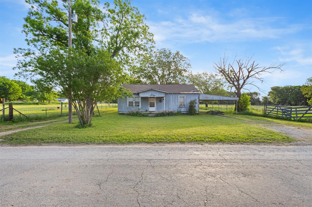 a front view of house with yard and green space