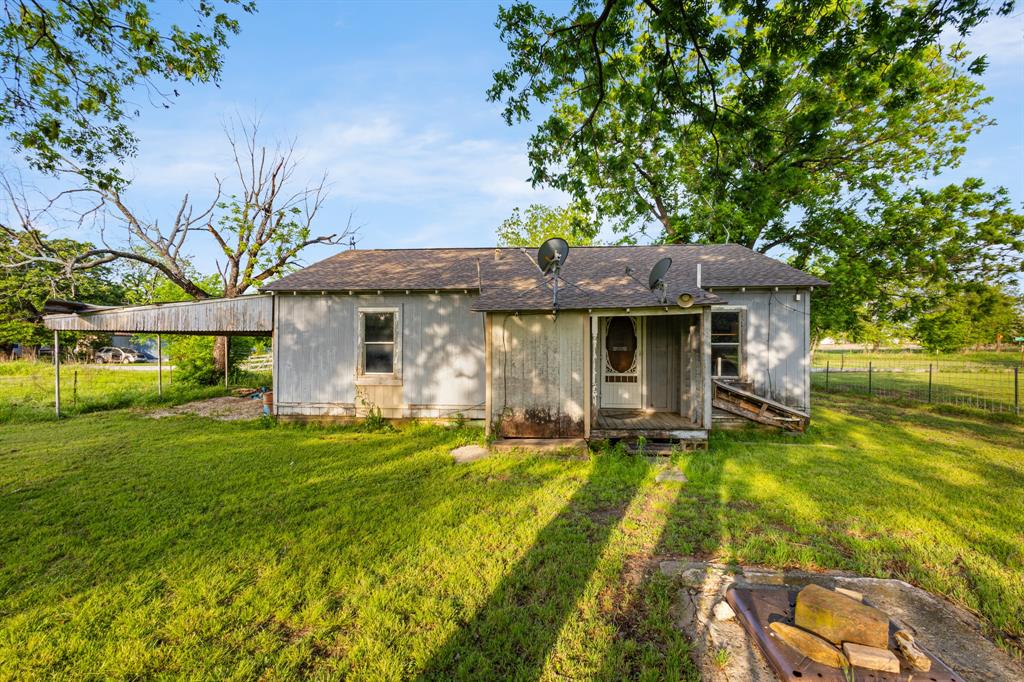 201 Proctor Lane Sunset, TX 76270 - Photo 15 of 18 a front view of a house with a yard table and chairs