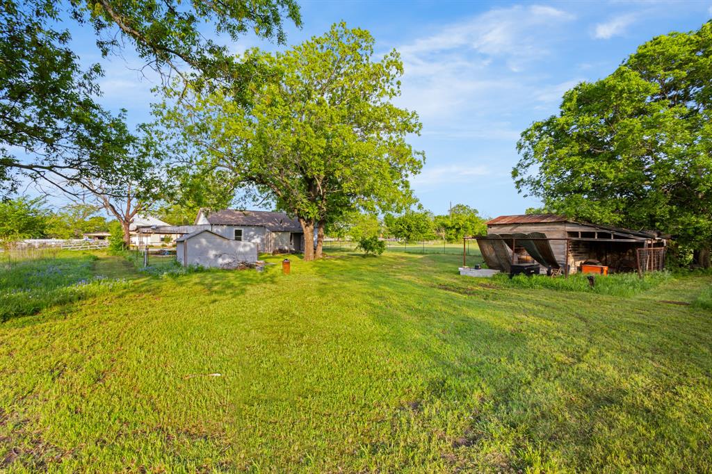 201 Proctor Lane Sunset, TX 76270 - Photo 16 of 18 a backyard of a house with table and chairs