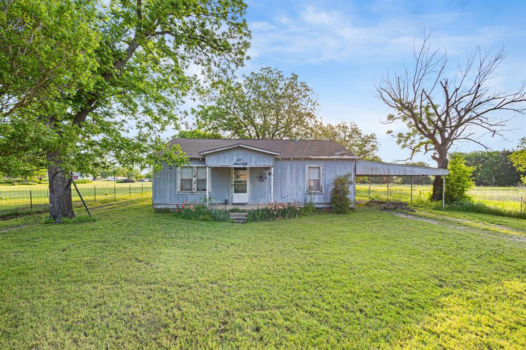 201 Proctor Lane Sunset, TX 76270 - Photo 2 of 18 a front view of a house with garden