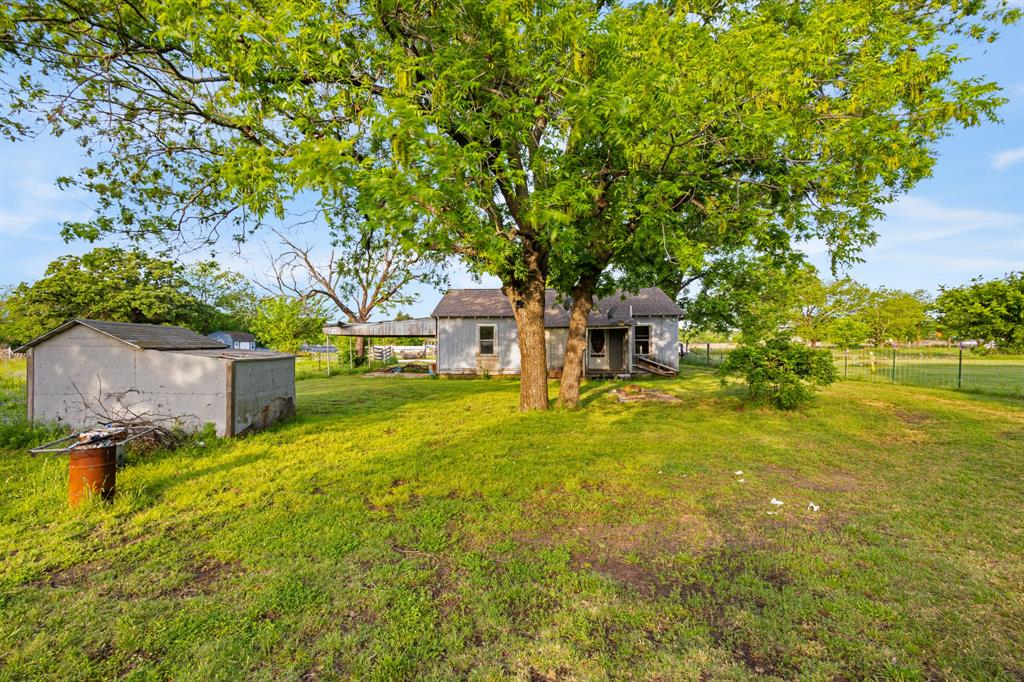 201 Proctor Lane Sunset, TX 76270 - Photo 4 of 18 a front view of a house with a yard