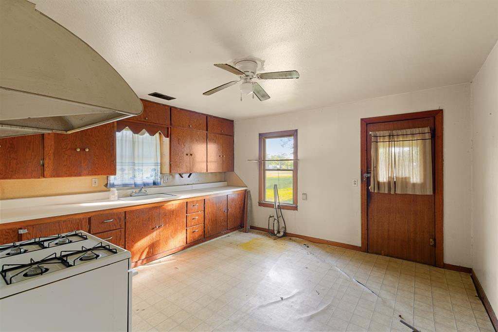 201 Proctor Lane Sunset, TX 76270 - Photo 6 of 18 a view of a kitchen with microwave and windows