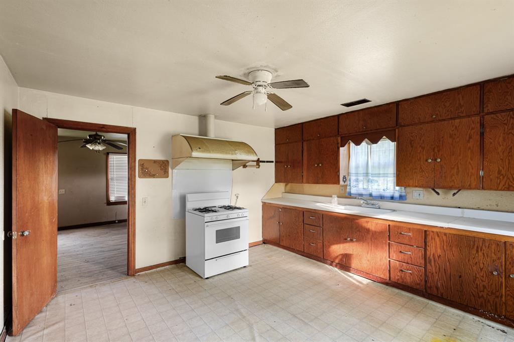 201 Proctor Lane Sunset, TX 76270 - Photo 7 of 18 a kitchen with refrigerator and cabinets