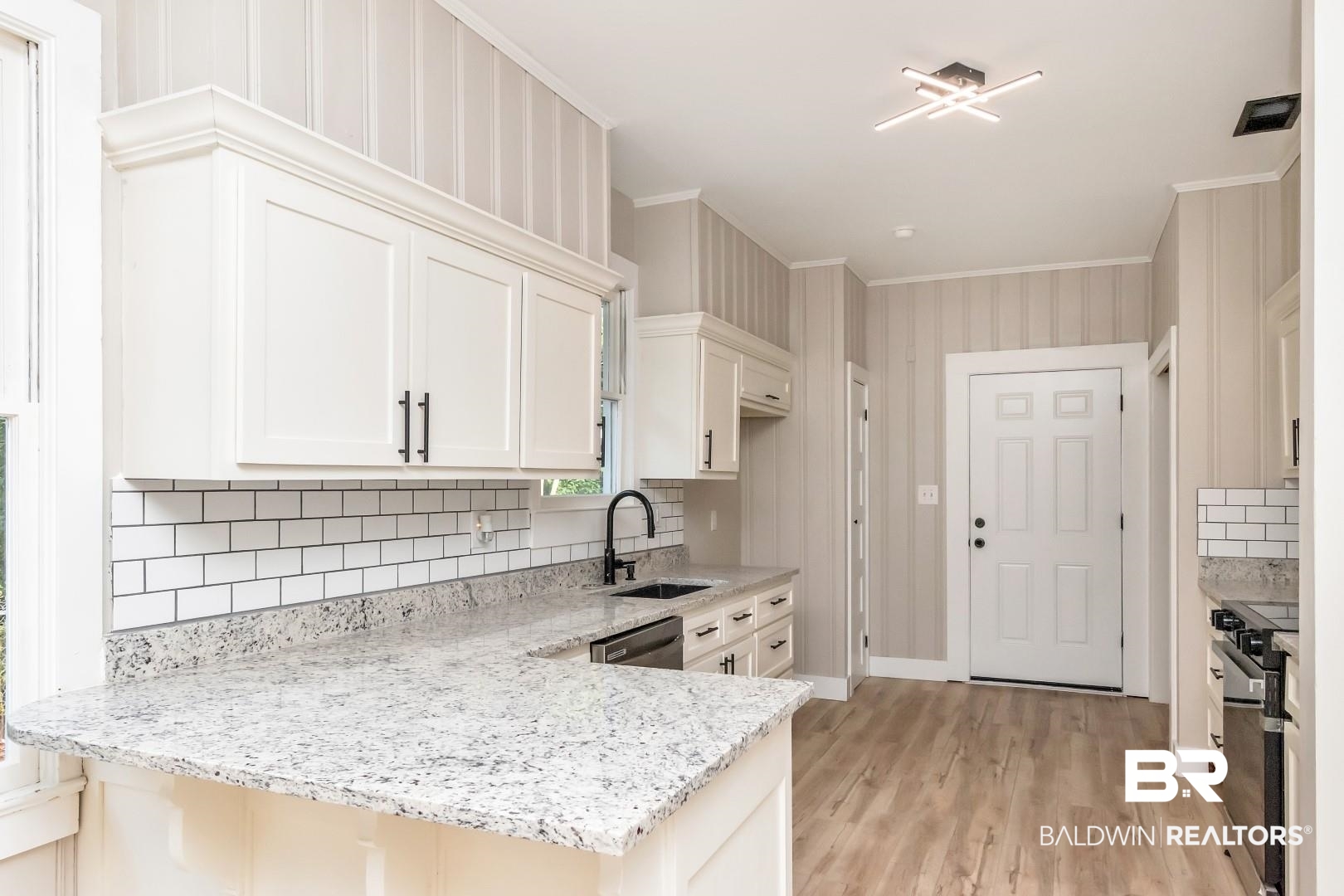 555 Michigan Avenue Mobile, AL 36604 - Photo 12 of 28 Kitchen with white cabinetry, sink, and light stone countertops