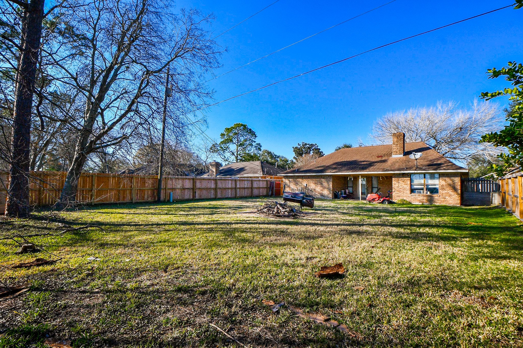 68 Alexander Court Angleton, TX 77515 - Photo 12 of 15 a front view of a house with a yard table and chairs