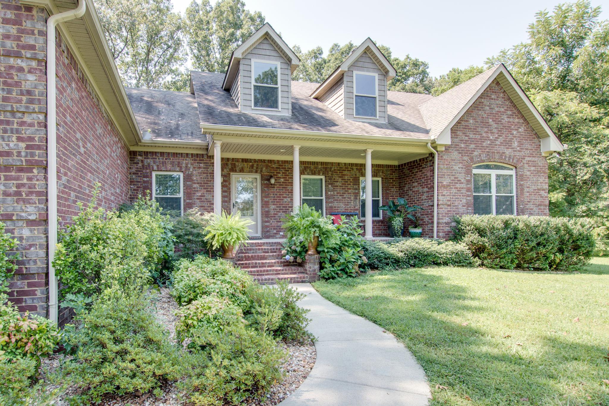 6629 Burnt Knob Road Murfreesboro, TN 37128 - Photo 2 of 27 Walkway leads to a lovely front porch and lush landscaping with plenty of room to sit and contemplate the universe... or just have a glass of iced tea:)