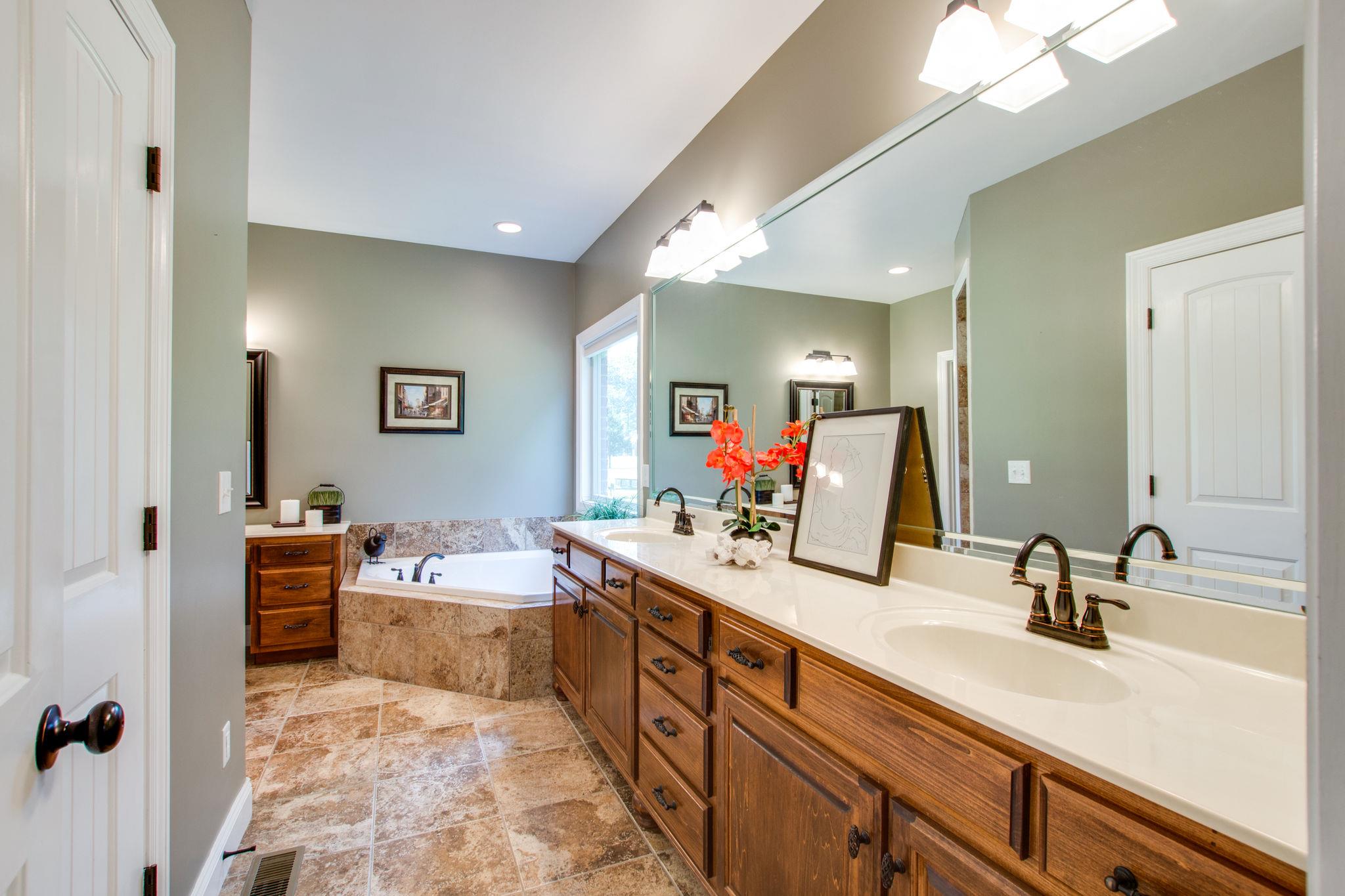 6629 Burnt Knob Road Murfreesboro, TN 37128 - Photo 11 of 27 Long double vanity has double stack of drawers in the middle. The garden tub is tucked away in the corner with a large picture window out to back yard.