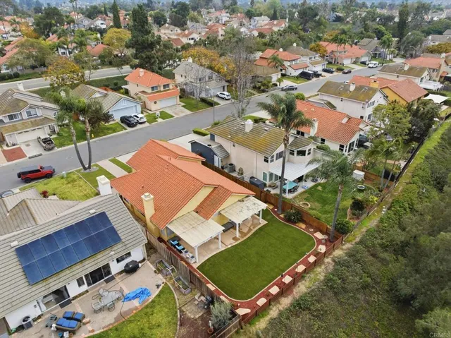 an aerial view of a house with a yard basket ball court and outdoor seating