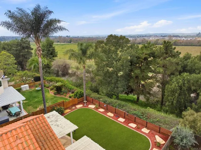 an aerial view of a house with a garden and balcony