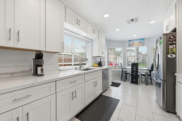a kitchen with a stove a microwave and refrigerator