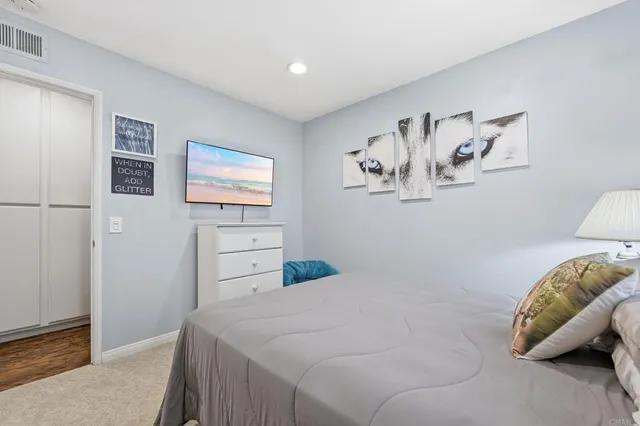 a bedroom with a bed and a couch