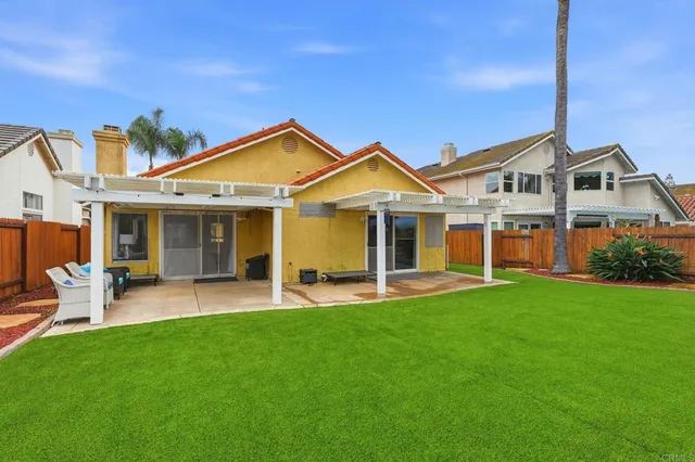 a front view of a house with a garden and patio