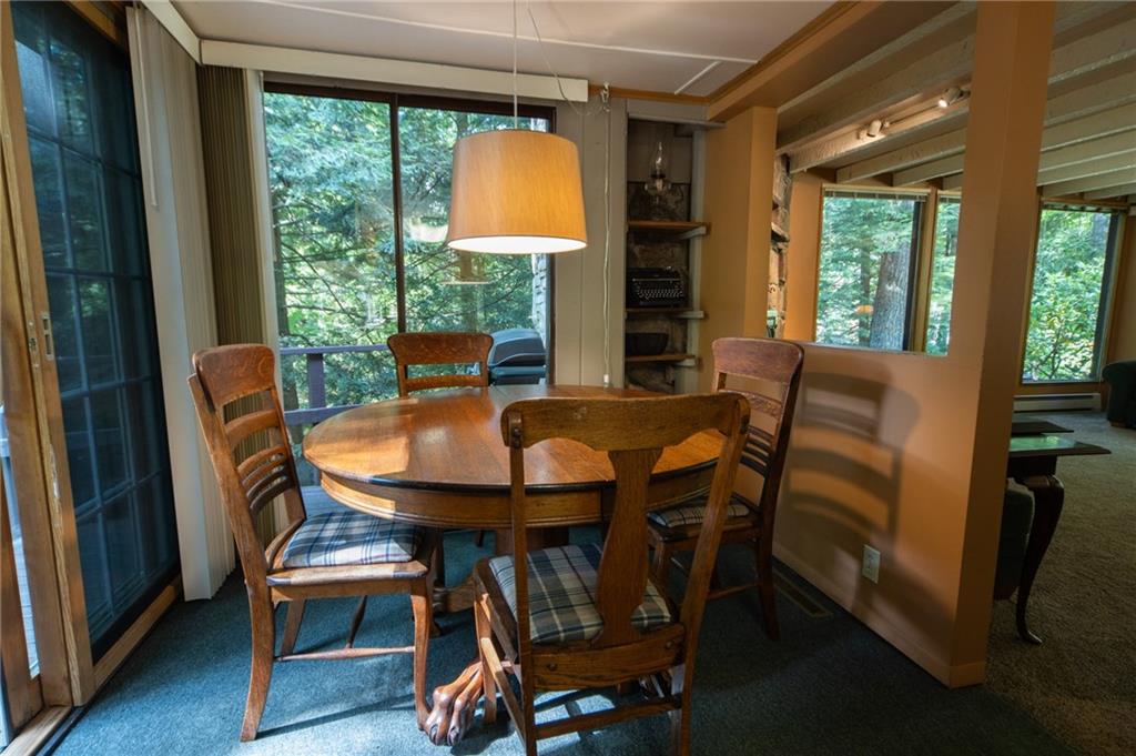 1223 Triple Creek Road Champion, PA 15622 - Photo 14 of 25 Dining Room Walls of Windows and Stone Cubby with Shelving. Sliding Doors open to Wrap Around Deck.