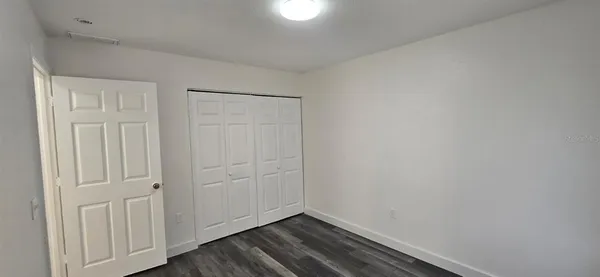 a view of room with wooden floor