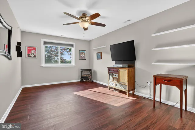 a hallway with wooden floor table and chairs