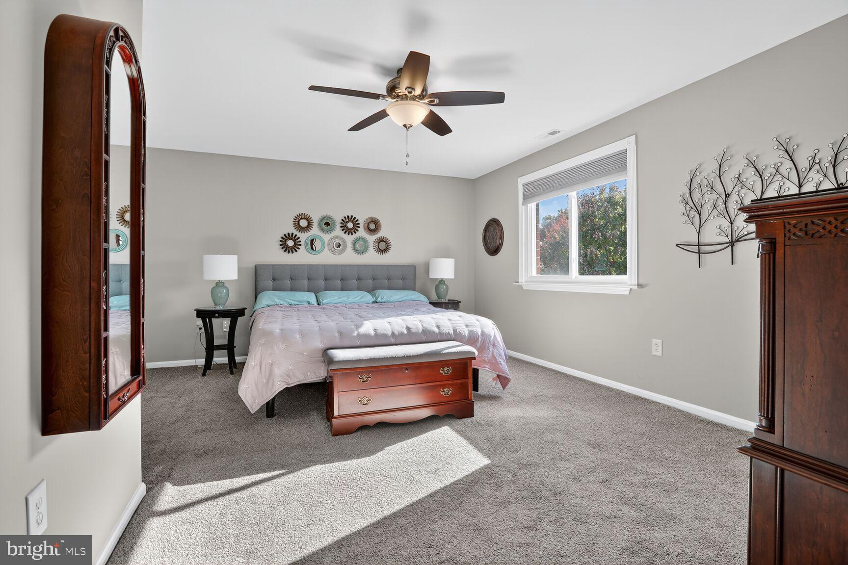 4106 Chardel Road, Unit 2G Baltimore, MD 21236 - Photo 16 of 25 a bedroom with a bed and a chandelier