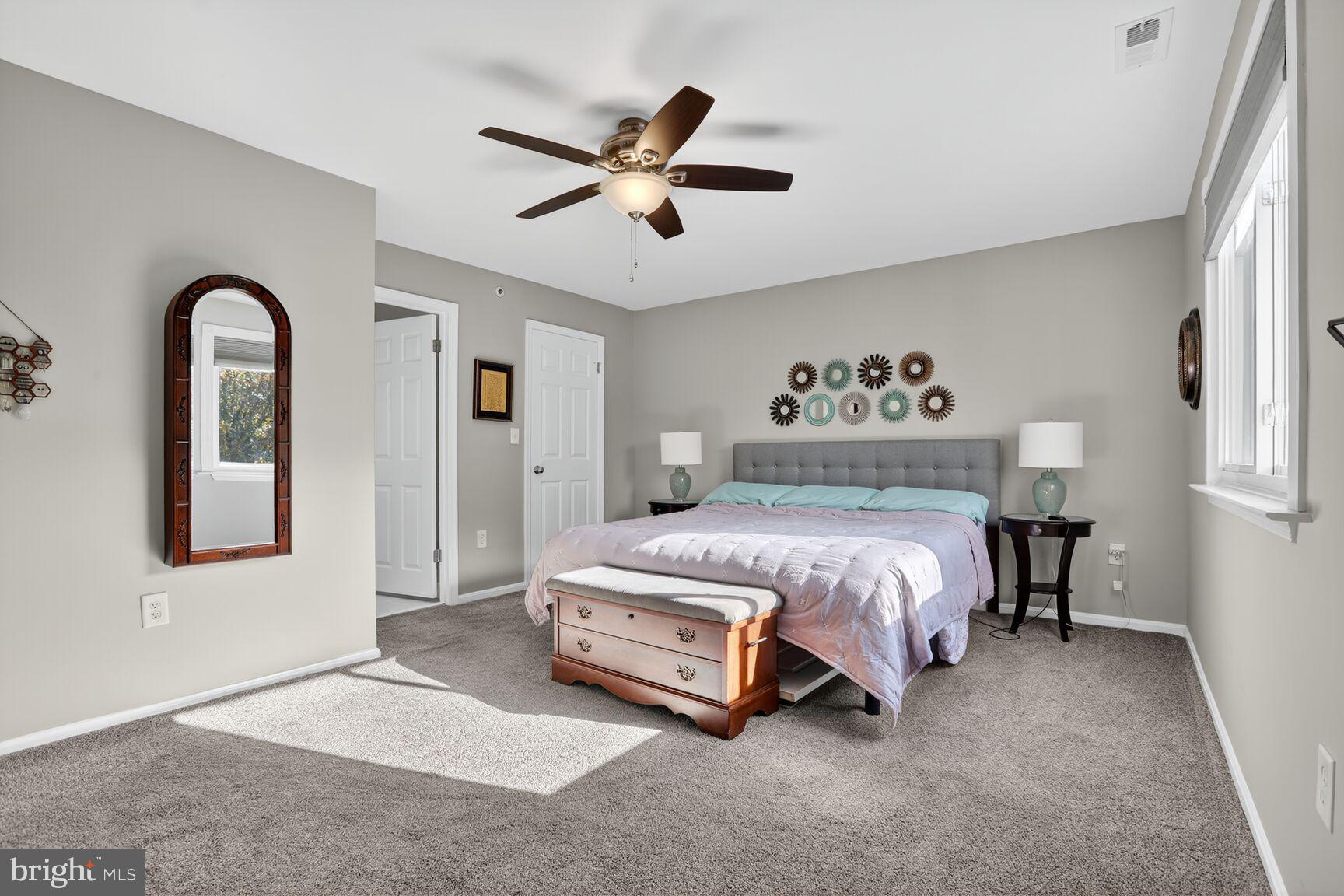 4106 Chardel Road, Unit 2G Baltimore, MD 21236 - Photo 17 of 25 a spacious bedroom with a bed and a chandelier