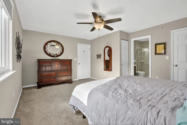 a spacious bedroom with a bed and a chandelier
