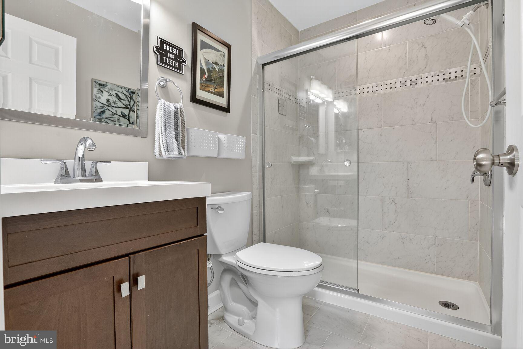 4106 Chardel Road, Unit 2G Baltimore, MD 21236 - Photo 19 of 25 a bathroom with a sink a toilet and shower