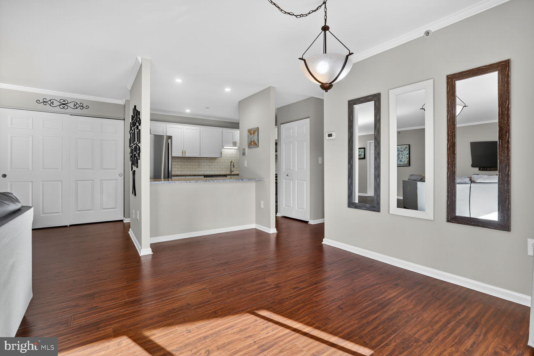 4106 Chardel Road, Unit 2G Baltimore, MD 21236 - Photo 8 of 25 a view of a hallway with wooden floor and a kitchen