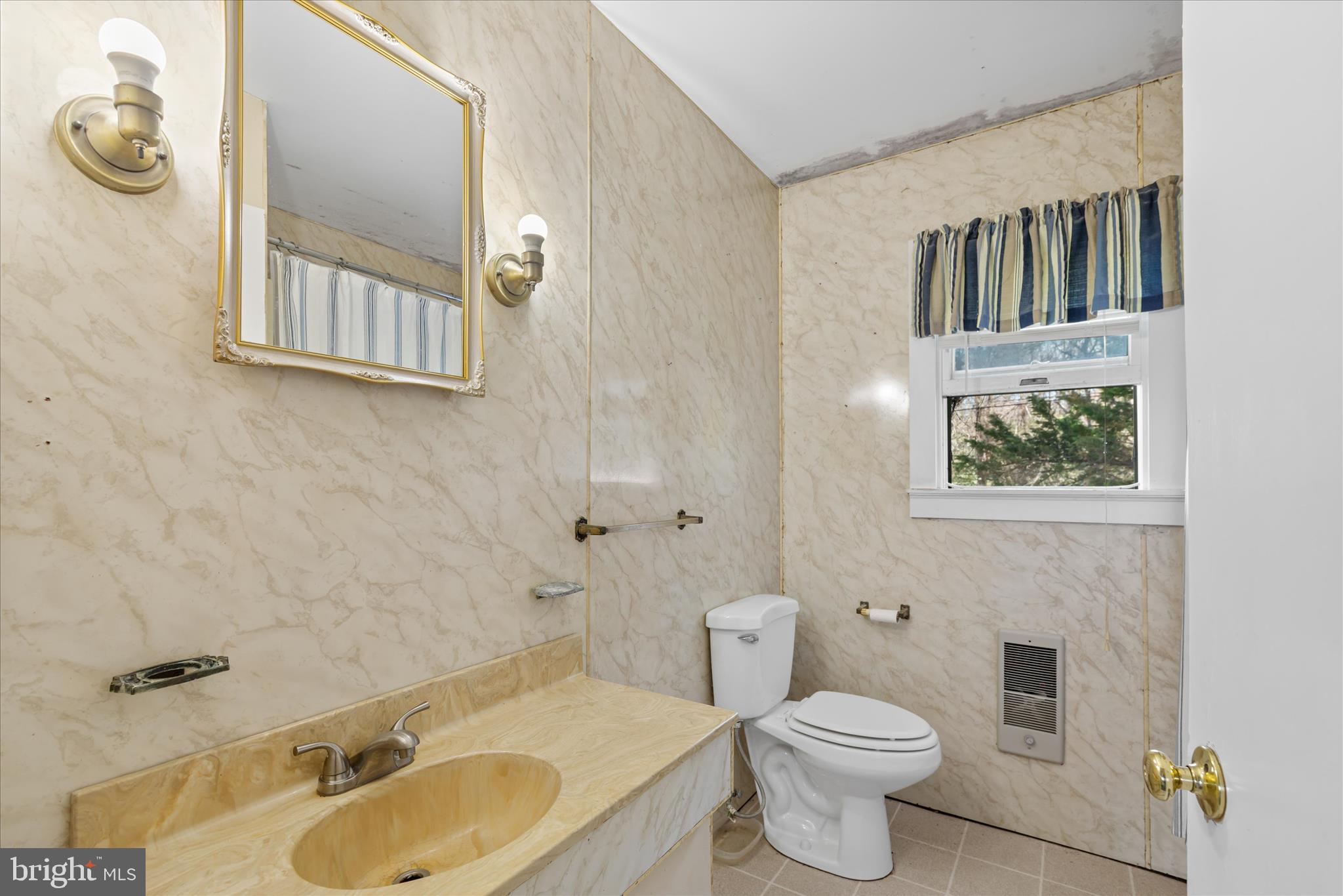28359 Martins Farm Road Milton, DE 19968 - Photo 29 of 63 a bathroom with a sink toilet and mirror