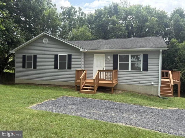 a backyard of a house with barbeque oven