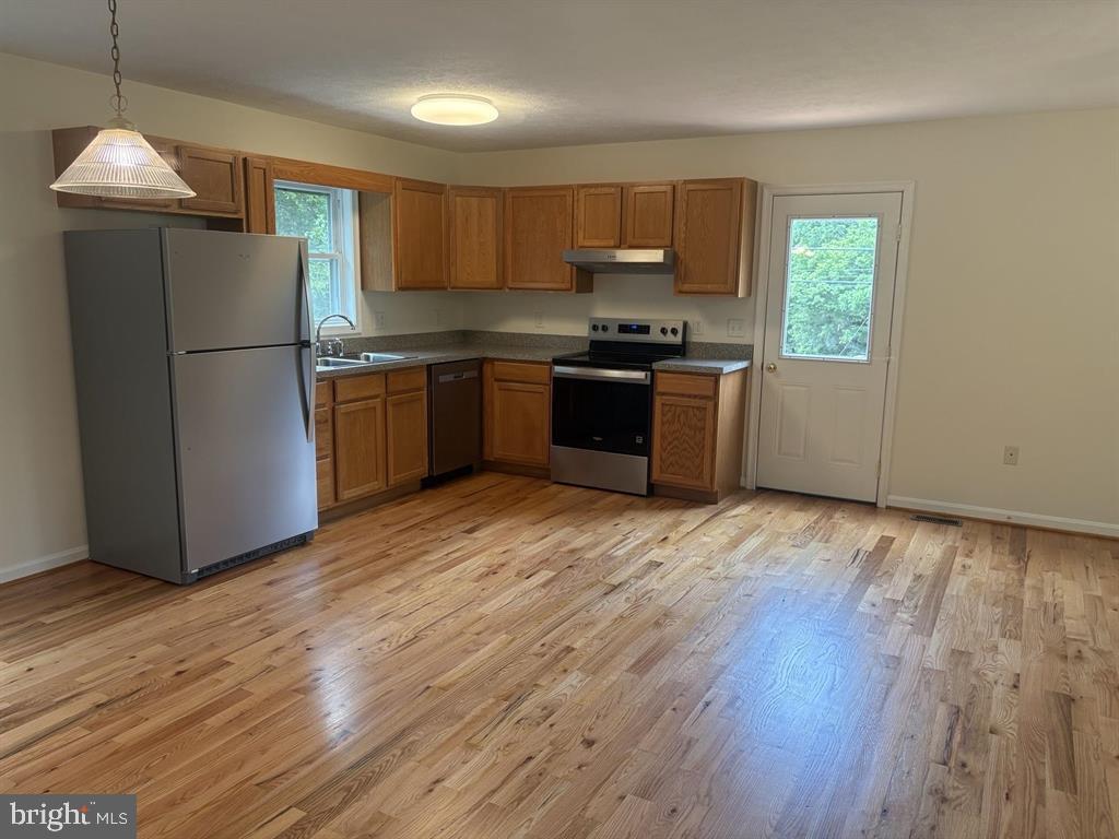 296 Bryce Boulevard Mount Jackson, VA 22842 - Photo 4 of 20 a kitchen with granite countertop wooden floors stainless steel appliances and window