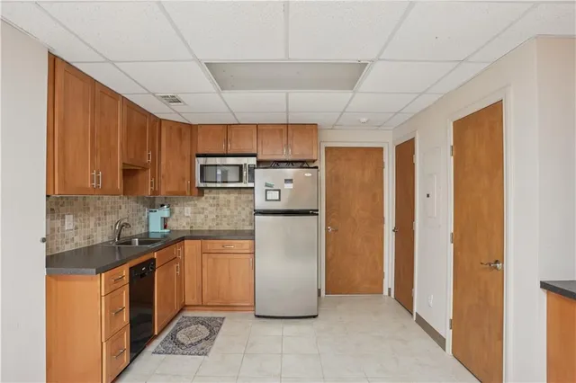 a kitchen with stainless steel appliances granite countertop a refrigerator and a sink