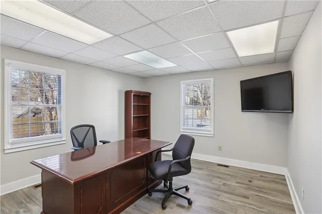 a view of a workspace with furniture and a window