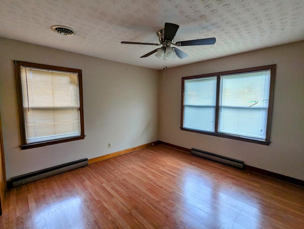 714 Glendale Road Galax, VA 24333 - Photo 13 of 26 a view of an empty room with wooden floor and a window