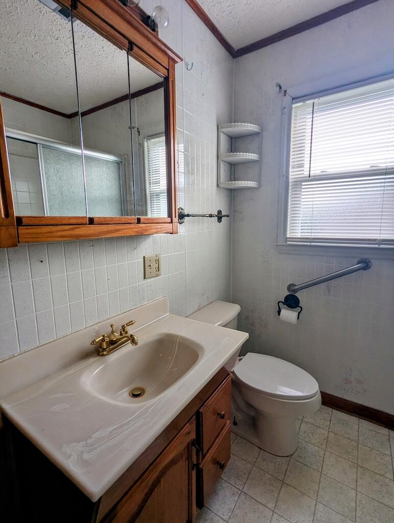 714 Glendale Road Galax, VA 24333 - Photo 14 of 26 a bathroom with a sink a toilet and a window