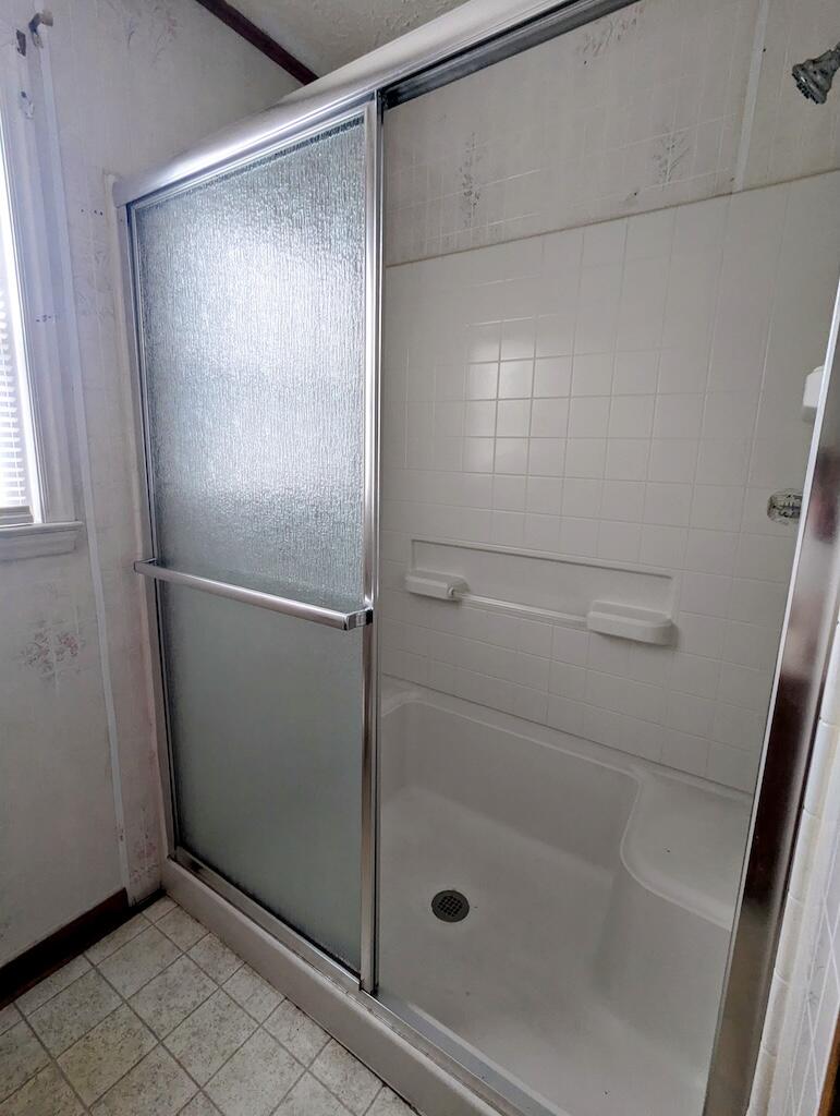 714 Glendale Road Galax, VA 24333 - Photo 15 of 26 a bathroom with a glass shower door