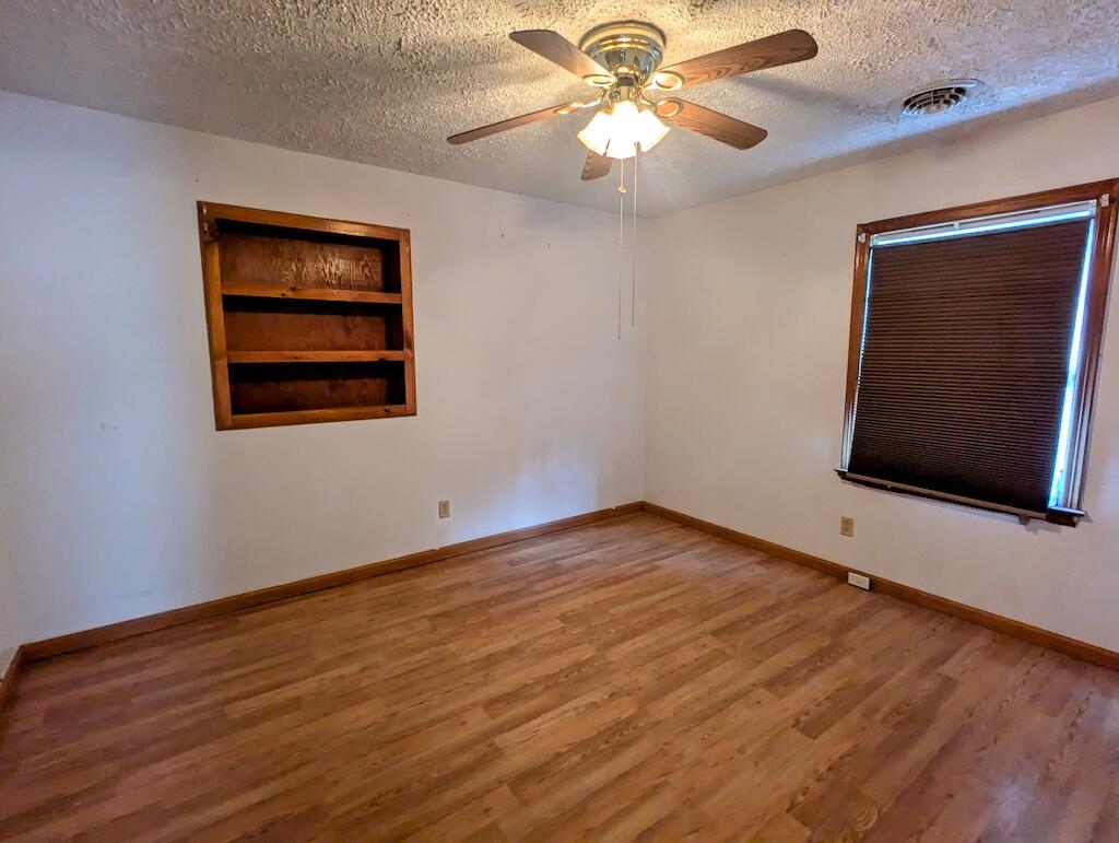 714 Glendale Road Galax, VA 24333 - Photo 16 of 26 a view of an empty room with wooden floor and a window