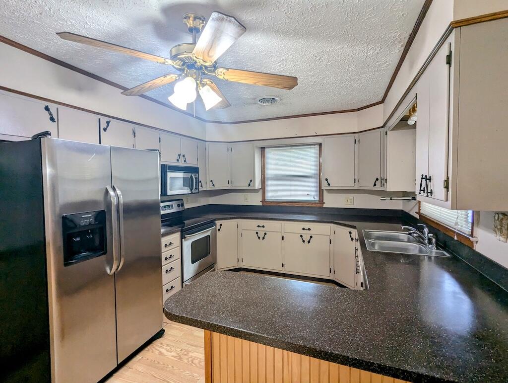 714 Glendale Road Galax, VA 24333 - Photo 10 of 26 a kitchen with stainless steel appliances granite countertop a sink a stove counter space and cabinets