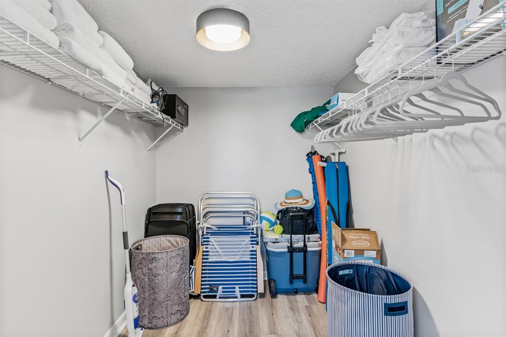 3210 Gulf Boulevard, Unit 307 Belleair Beach, FL 33786 - Photo 14 of 44 a view of storage and utility room with racks on the wall