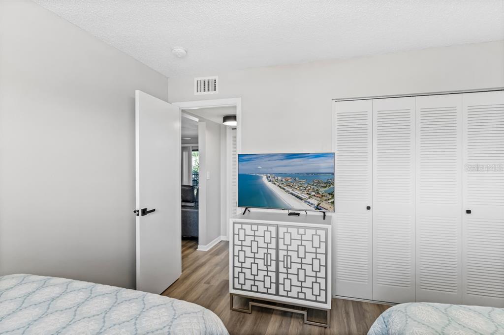 3210 Gulf Boulevard, Unit 307 Belleair Beach, FL 33786 - Photo 23 of 44 a bedroom with a bed and wooden floor