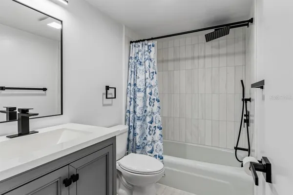 a bathroom with a sink a toilet and a bathtub