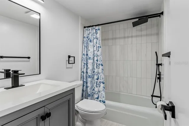 a bathroom with a sink a toilet and a bathtub