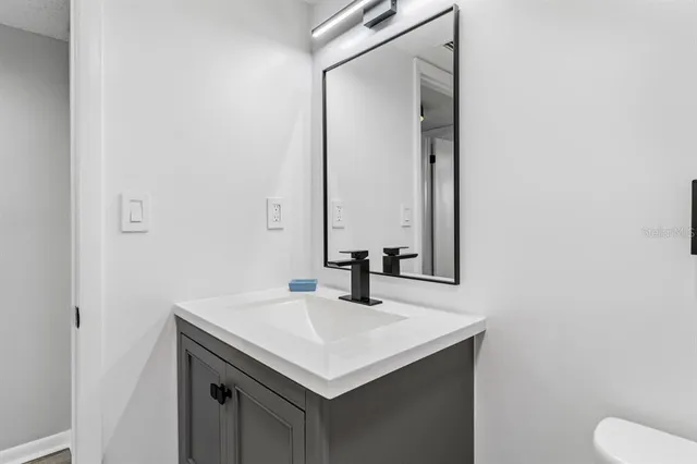 a bathroom with a sink and a mirror