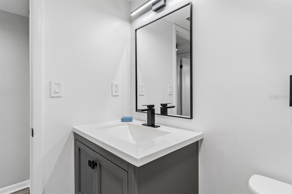 3210 Gulf Boulevard, Unit 307 Belleair Beach, FL 33786 - Photo 25 of 44 a bathroom with a sink and a mirror