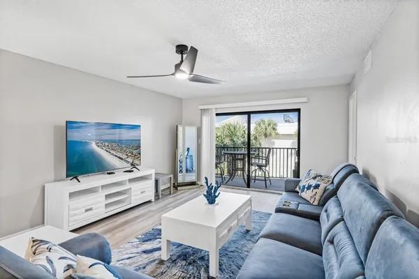 a living room with furniture and floor to ceiling window
