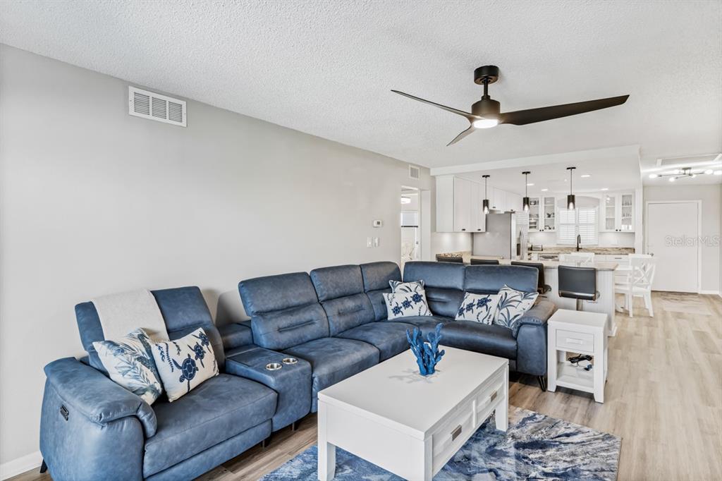 3210 Gulf Boulevard, Unit 307 Belleair Beach, FL 33786 - Photo 8 of 44 a living room with furniture and a ceiling fan