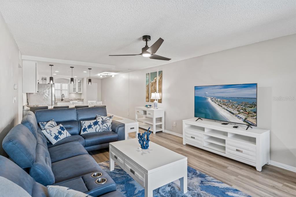 3210 Gulf Boulevard, Unit 307 Belleair Beach, FL 33786 - Photo 9 of 44 a living room with furniture and a wooden floor