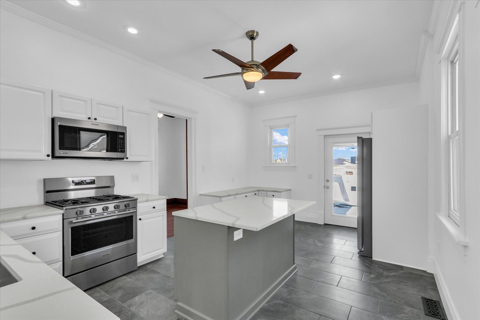 202 East Daggy Street Tuscola, IL 61953 - Photo 11 of 45 a kitchen with stainless steel appliances a white stove top oven a sink dishwasher and a refrigerator with wooden floor
