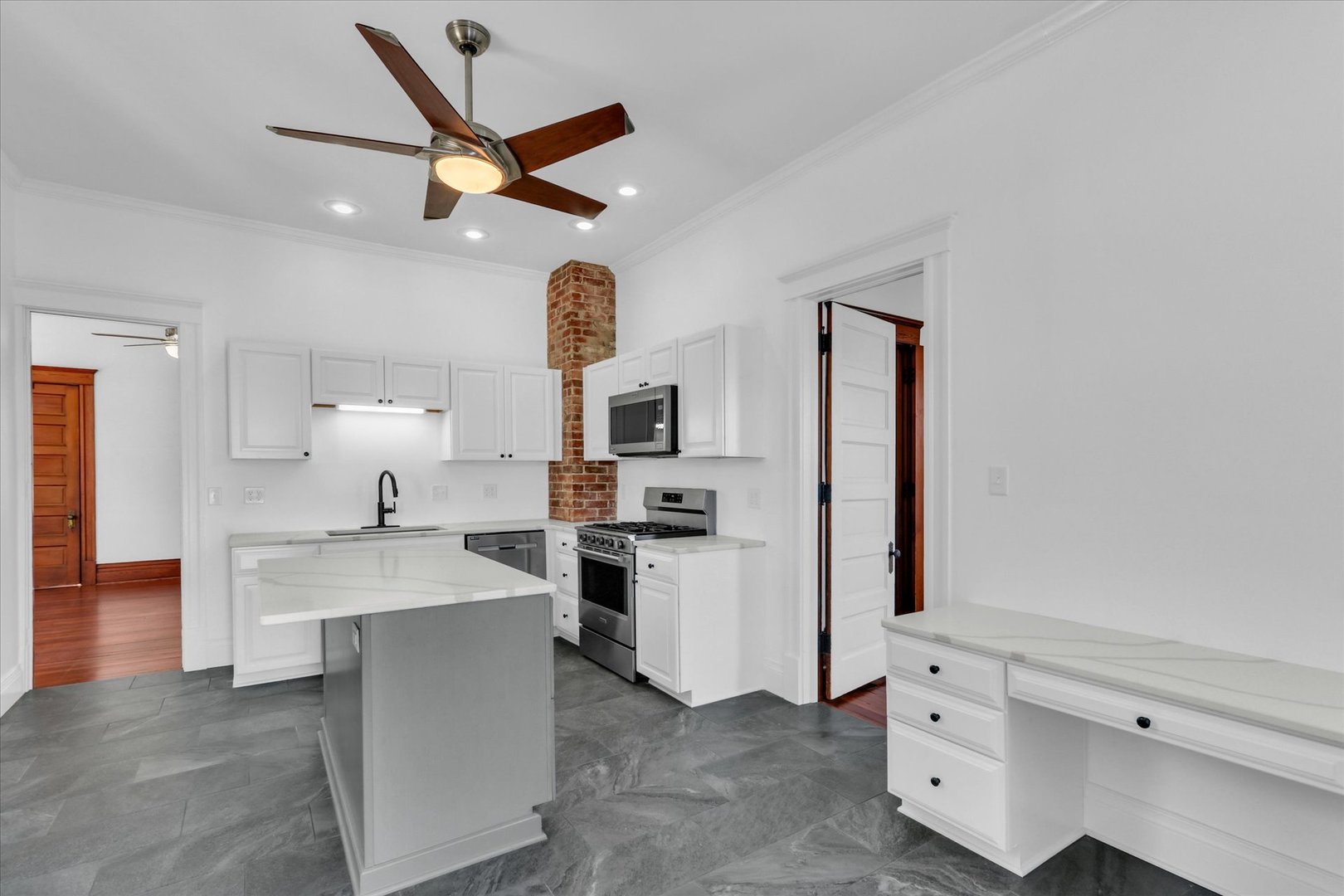 202 East Daggy Street Tuscola, IL 61953 - Photo 12 of 45 a open kitchen with white cabinets and stainless steel appliances