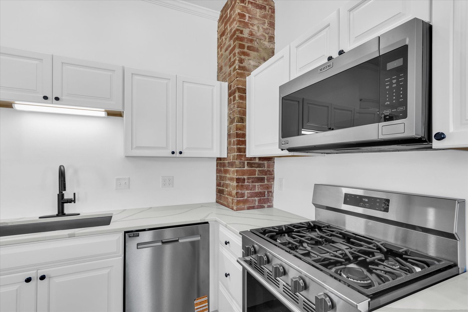 202 East Daggy Street Tuscola, IL 61953 - Photo 14 of 45 a kitchen with stainless steel appliances a sink a stove and cabinets